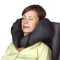 Sleeping woman wearing a travel neck pillow