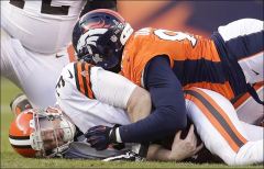 Cleveland Browns quarterback Brandon Weeden, left, is sacked by Broncos defensive end Elvis Dumervil.
