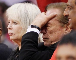 Los Angeles Clippers owner Donald Sterling (R) puts his hand over his face as he sits courtside with his wife Shelly (L) while the Clippers trail the Chicago Bulls in the second half of their NBA basketball game in Los Angeles December 30, 2011. 